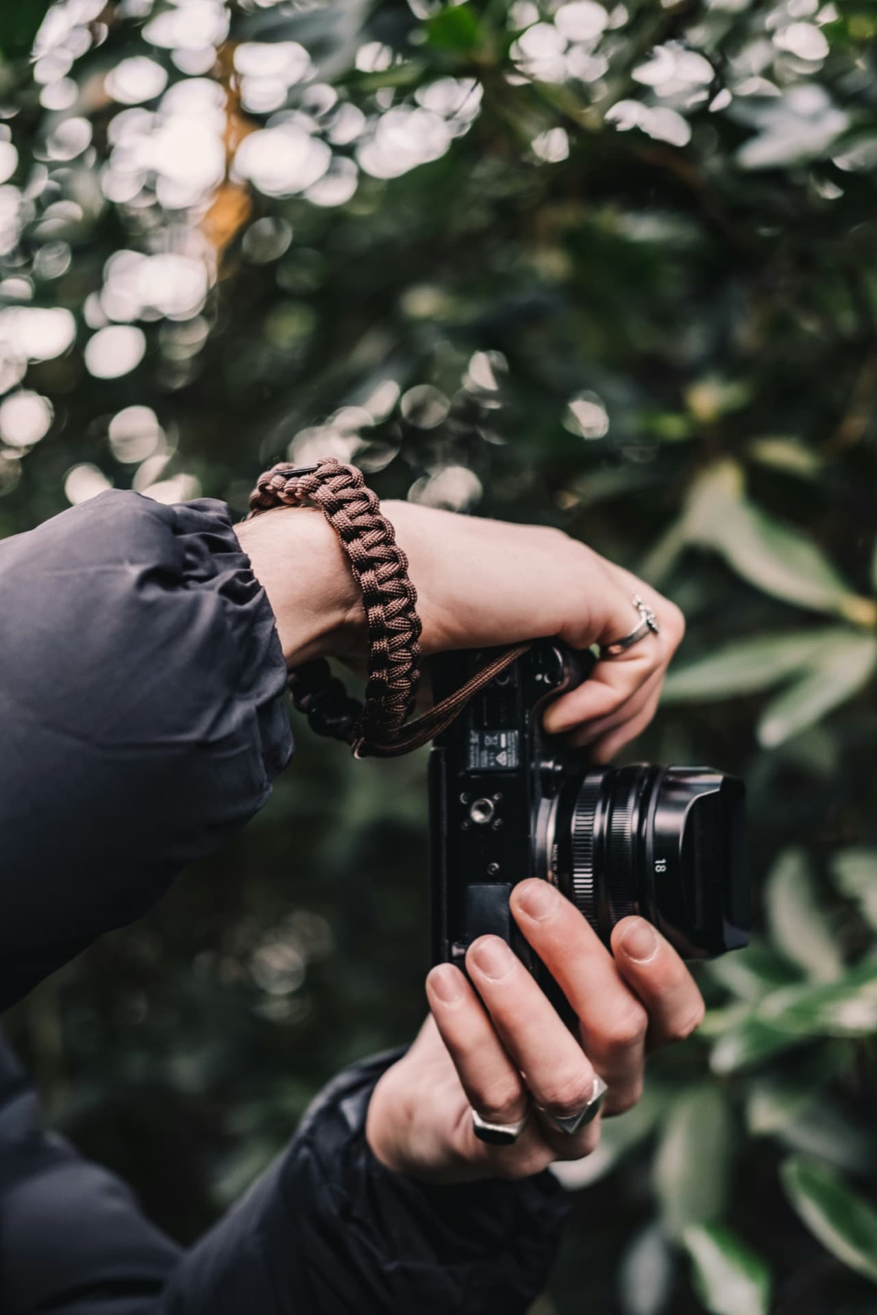 Thomas inspects the durability of custom tied paracord camera strap